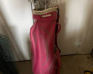 Vintage women's First Flight golf clubs in cute bright pink bag.
