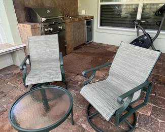 Pair of swivel rockers and small cocktail table. 