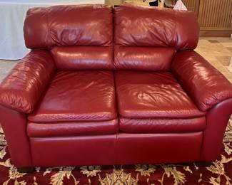 Cranberry colored faux leather love seat, 58" x 36" x 30"