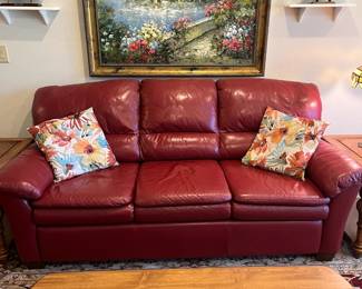 Cranberry colored faux leather sofa, 80" x 36" x 36"