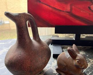 Old Mexico terra cotta duck pitcher and an antique cast iron rabbit from an old fence post 