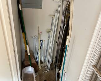 Cleaning supplies: mops, brooms, buckets, ironing boards