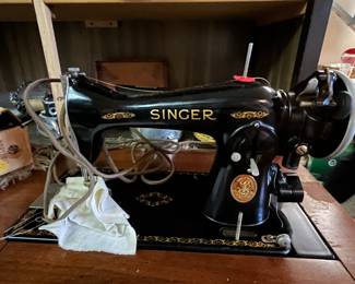 Antique Singer sewing machine and cabinet.....