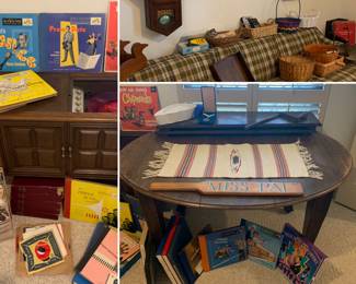 Solid oak table w/wood wheels & 2 leaves, plaid sofa, Console, records, baskets, clock (has been wound to tight) 