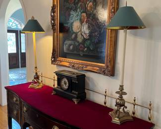 Brass pair of carp tall lamps   On top of buffet that has custom cover with brass back 