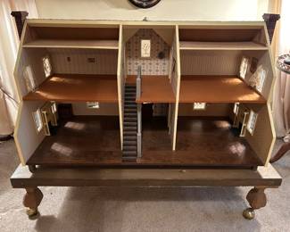 Very large vintage dollhouse beautifully crafted; on rolling wooden platform.  Measurement includes the platform. Measures 50w 30d 38h. --- $350