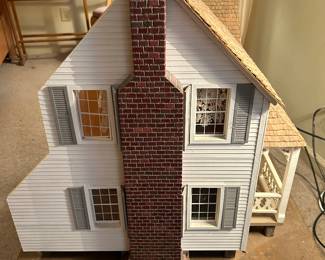 Very large vintage dollhouse beautifully crafted; on rolling wooden platform.  Measurement includes the platform. Measures 50w 30d 38h. --- $350