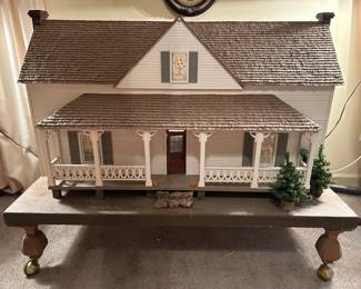 Very large vintage dollhouse beautifully crafted; on rolling wooden platform.  Measurement includes the platform. Measures 50w 30d 38h. --- $350
