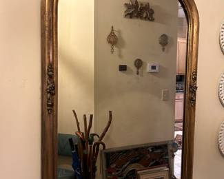 Vintage gold tone mirror with floral accents. Note glass was likely replaced, it is not beveled. Hanging hardware is installed.  Measures 25 x 36.  --- $80