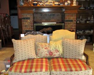 French country settee with seat caning and lush upholstery.