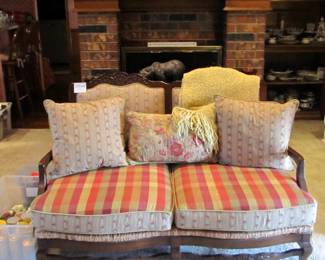 French country settee with seat caning and lush upholstery.