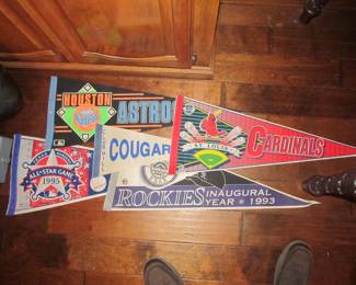 We have an incredible sports memorabilia collection that includes books, bobbleheads, sports banners, commemorative drinks, vintage sports games, & hats.