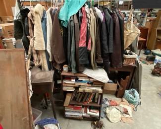 Bookcase full of mostly Hardbacks, plus a lot more books yet to be transported to the estate facility. Also a rack full of jackets and other clothing. There is a lot more clothing to bring to the site
