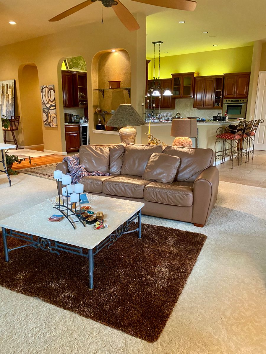 Welcome to the lovely living room, leather sofa, matching travertine stone table set, two reading chairs 