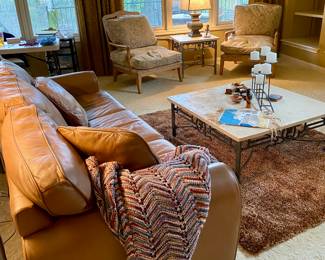 Welcome to the lovely living room, leather sofa, matching travertine stone table set, two reading chairs 