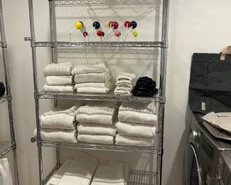 Bath linens and racks for sale during in-person shopping hours only.