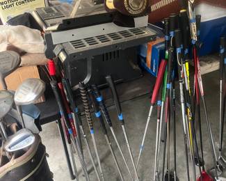 A COUPLE DOZEN GOLF CLUBS