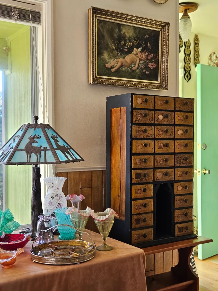1900's Folk Art Notions cabinet (34 x 20 x 10") made from old cigar boxes; 1920's slag glass deer lamp, antique whimsical cherub oil painting.