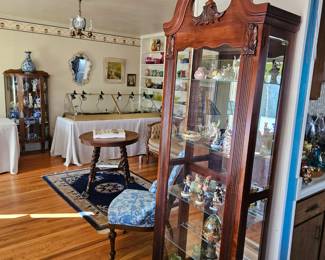 Lighted display cabinet with figurines, and Goebel/Hummel figurines.
