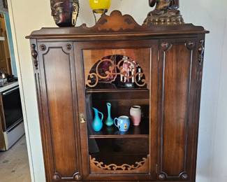 Art Deco cabinet, Bronze buddha's and a deco glass ball on stand.