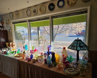 A myriad collection of antique glassware, china, and decorative items.