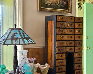 1900's Folk Art Notions cabinet (34 x 20 x 10") made from old cigar boxes; 1920's slag glass deer lamp, antique whimsical cherub oil painting.