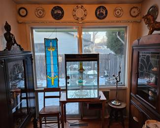Art Deco cabinets, Swarovski display cabinet, school desk and chair, Deco hat stand and plates on the wall.