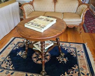 Victorian couch with goose down cushions; a ball and claw foot round table; Chinese hand woven area rug. 