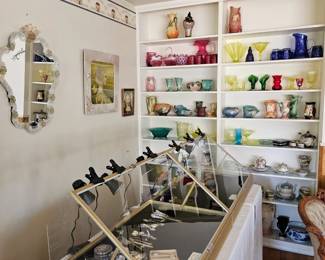 Shelves of vintage glass and pottery.