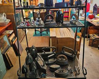Bakers rack with old irons.