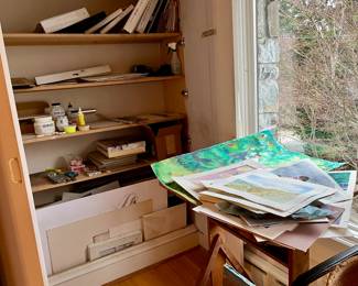 Artist's supplies and unframed paintings