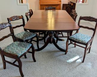 Dining Table Sold - but there are 8 Antique Carved Rose Back Upholstered Chairs - $15 each (that is the 75% off price).  33" tall, 16.5" wide, 19" to seat.