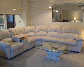 Cream Leather Reclining Sofa - two seats on left end recline - wall hugger. $600.00