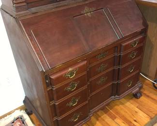CLOSE UP VIEW OF RARE MAHOGANY MUSEUM QUALITY SENTENIAL SECRETARY DESK WITH ORNATE CHIPPENDALE BALL & CLAW FEET AND SIGNED MANUFACURING WOOD MAKERS SIGNATURE ON REVERSE CIRCA 1876