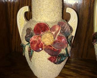 CLOSE UP VIEW OF RARE MANUFACTURING S IGNED POTTERY GLASS SET OF VASES FROM THE LAWRENCE FISHER ESTATE SALE WITH ORIGINAL PHOTO OF FISHER FAMILY MEMBER IN FRONT OF AND ON THE FIRE PLACE MANTLE.