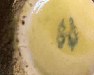 CLOSE UP VIEW OF MANUFACTURING SIGNATURE CLOSE UP VIEW OF RARE MANUFACTURING S IGNED POTTERY GLASS SET OF VASES FROM THE LAWRENCE FISHER ESTATE SALE WITH ORIGINAL PHOTO OF FISHER FAMILY MEMBER IN FRONT OF AND ON THE FIRE PLACE MANTLE.