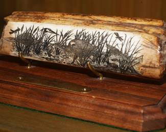 There are several scrimshaw etchings of different size and shape on bone by Rudy Waldroop.