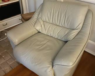 . . . one of two matching leather accent chairs