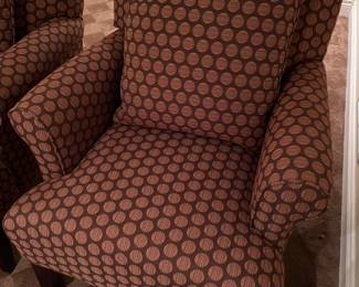 Close-up view of one of the two matching armchairs.