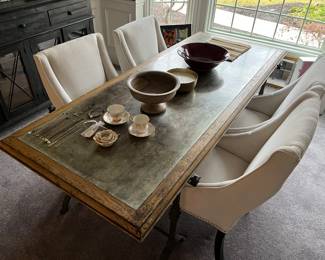 Rustic Scandinavian-/farmhouse-style dining table (see photo that follows for close-up view of legs); four matching upholstered chairs.