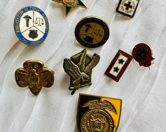 Large selection of lapel pins, including Red Cross, Boy Scouts, AAA, and many others