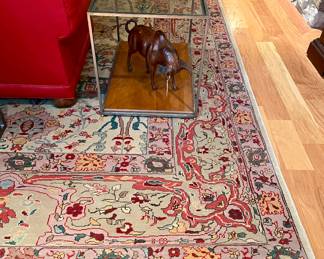 SOLD - large scale rug - neutral taupe main color of the rug, one condition report noted - there has been a cut created for electrical outlet but can be easily repaired - 19fx14f;                                                                                                             SOLD hand-crafted, steel frame side table with glass top and wood base - 31x20x23;                                                                                   SOLD leather covered bull - 22x7x14