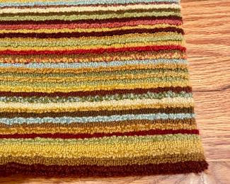 $100 - striped, looped rug with warm earth tones, custom bound - 58”x58”