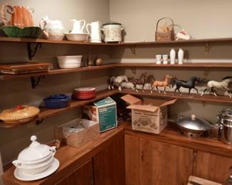 An assortment of pitchers, crock pots, wok, double-boiler, serving bowls, pie plates, etc.