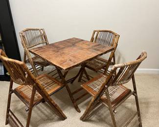 Vintage Bamboo folding table and 4 chairs.  Note while sturdy , finish is weathered. 