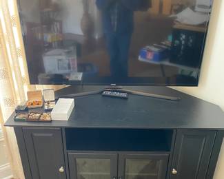 Black TV stand with storage and Samsung TV