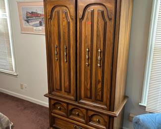 Five-piece bedroom set including two nightstands, armoire, and dresser with two mirrors