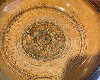 Brown Pottery Plate with Circular Textured Pattern