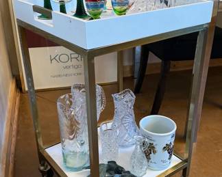 Bar cart, barware, framed posters from the 80s