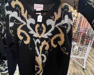 Lots of black & gold knit sweaters